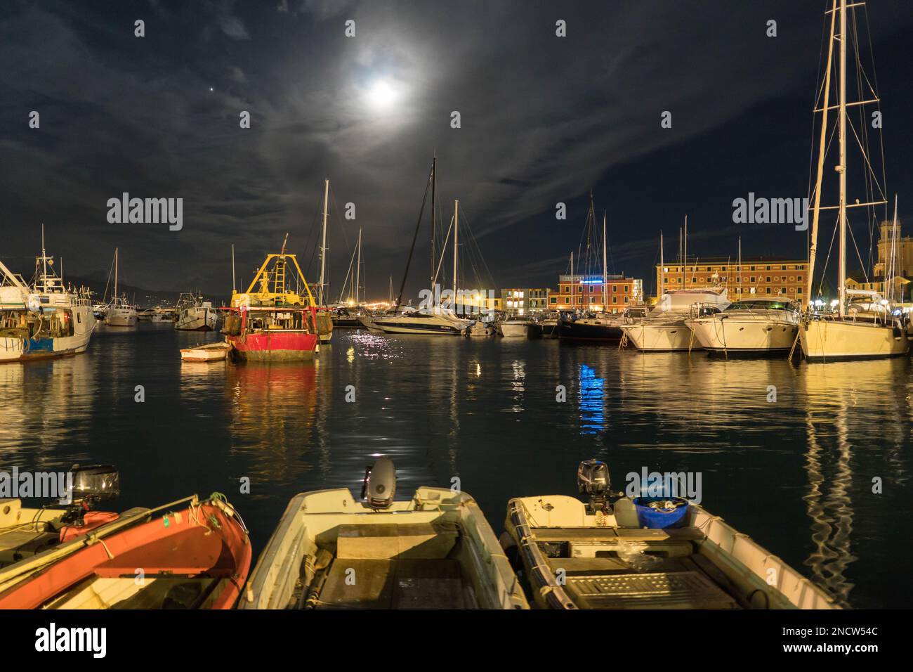 New Moon shining through the clouds and illuminating the harbour of Santa Margherita Ligure Italy. August 2022 Stock Photo