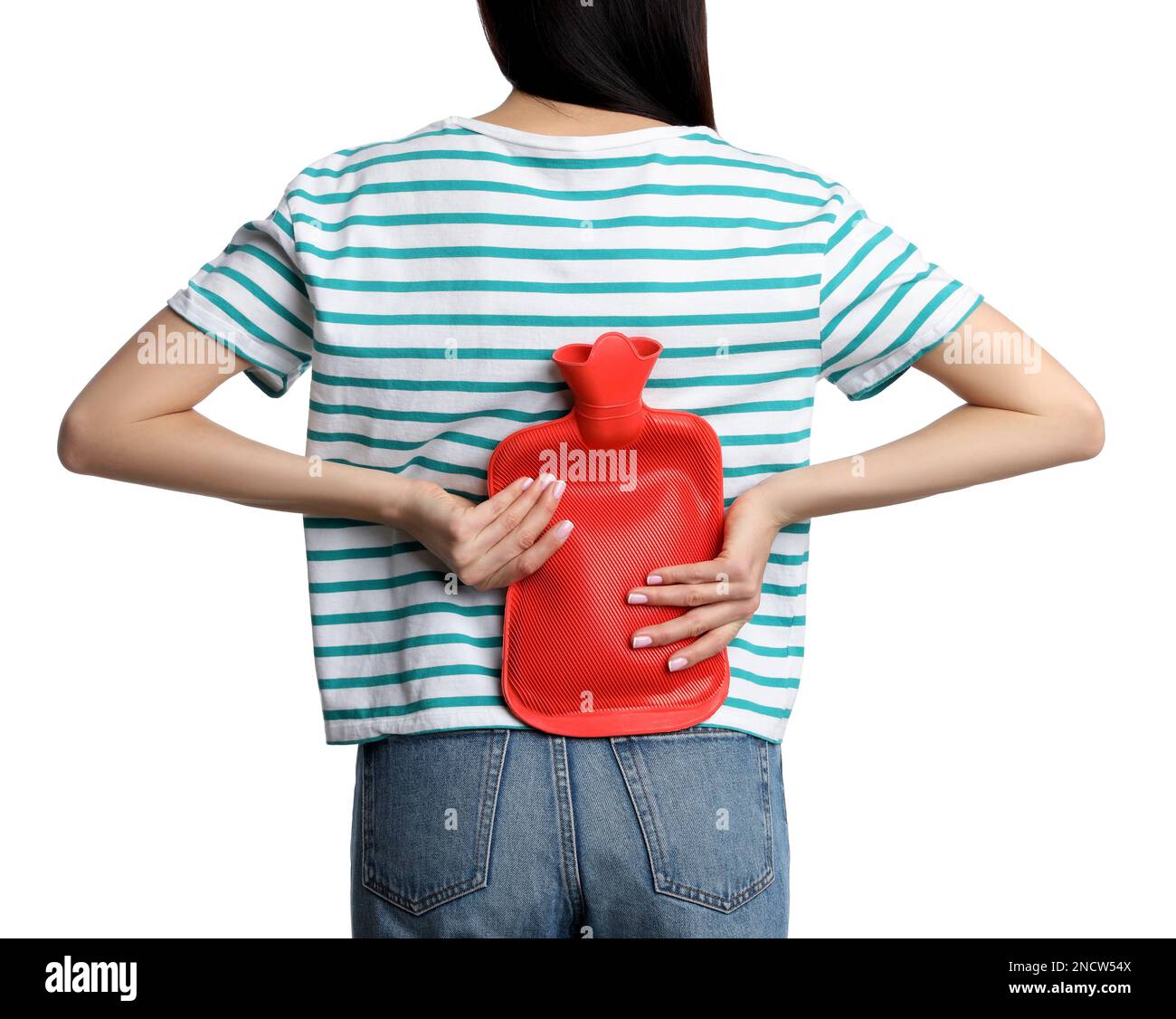Woman using hot water bottle to relieve low back pain on white
