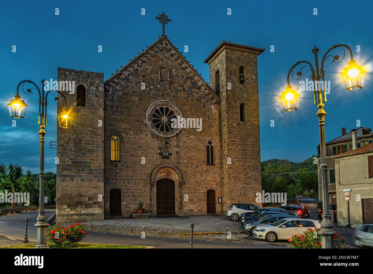 Facade of the church of San Salvatore at sunset. Located in front of the Rocca Monaldeschi, it is in Gothic style and has two towers on the sides. Stock Photo
