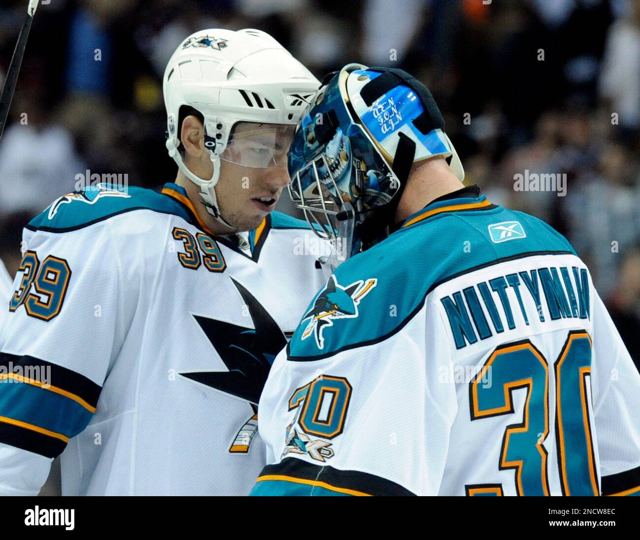 San Jose Sharks center Logan Couture (39) taps helmets with goaltender  Antero Niittymaki (30) from Finland after the Sharks beat the Colorado  Avalanche 4-2 during an NHL hockey game, Thursday, Oct. 21,