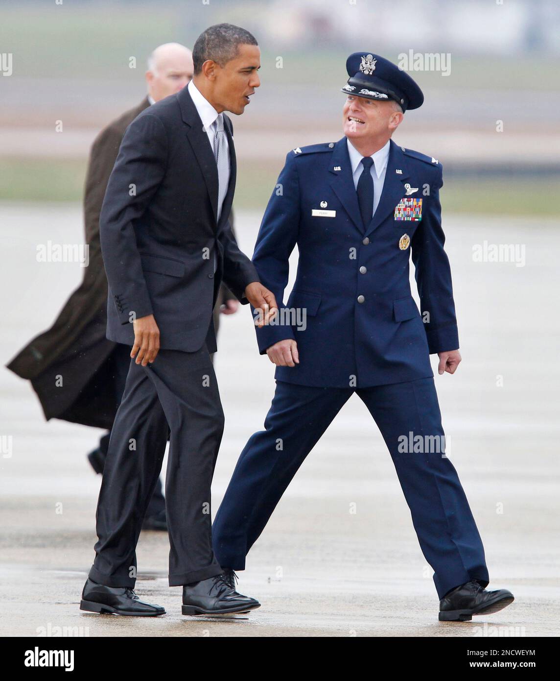 President Barack Obama is escorted by Col. Monty Perry, right ...