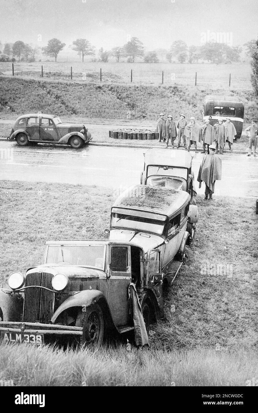 These ancient cars block the parkway beside the hard surface of a major