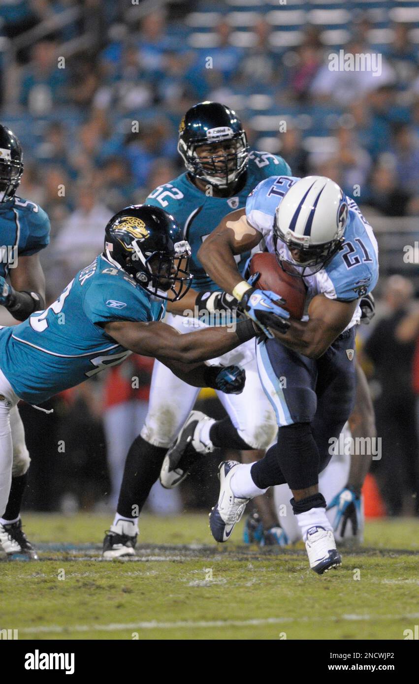 Tennessee Titans running back Chris Johnson (28) grabs the face mask of  Jacksonville Jaguars safety Gerald Alexander (42) in the first quarter of  an NFL football game in Nashville, Tenn., Sunday, Nov.