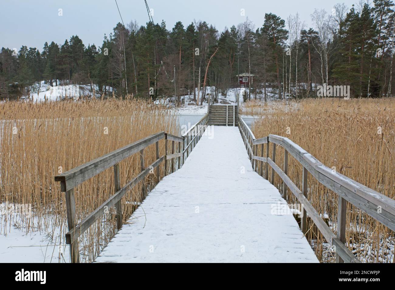 Winter landscape and walking bridge to the maritime recreational island of Linlo, Kirkkonummi, Finland. Stock Photo