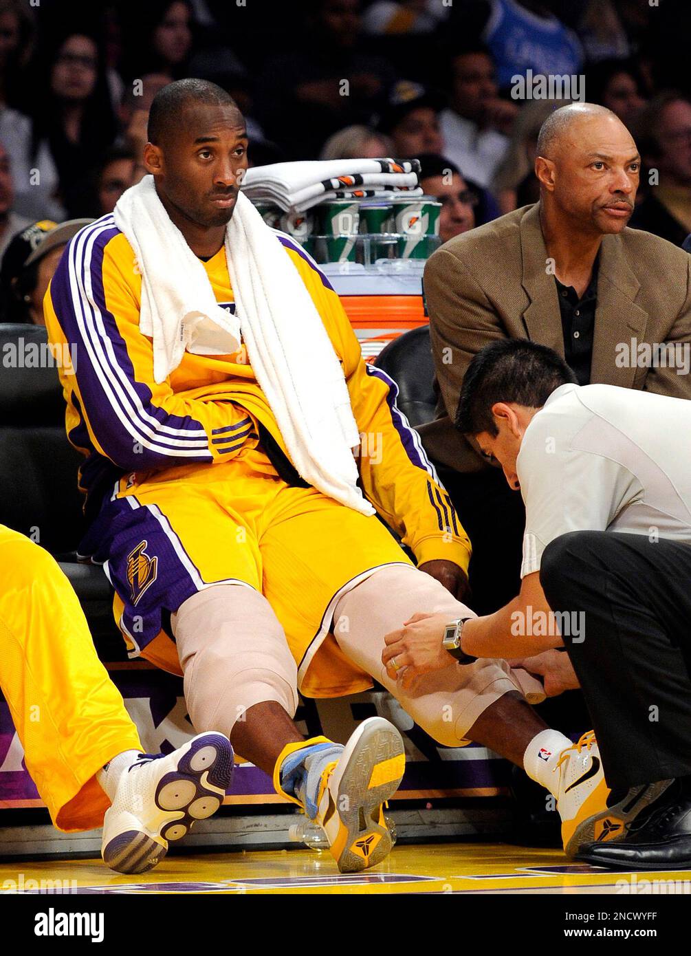 Los Angeles Lakers shooting guard Kobe Bryant, left, gets his knees bandaged during the second half of their preseason NBA basketball game against the Utah Jazz, Sunday, Oct. 17, 2010, in Los Angeles. (AP Photo/Mark J. Terrill) Stock Photo