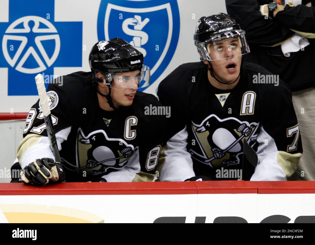 Pittsburgh Penguins Sidney Crosby, left, and Evgeni Malkin of Russia watch from the bench during the first period of a preseason NHL hockey game against the Detroit Red Wings in Pittsburgh Wednesday,