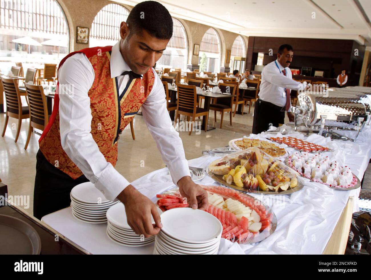 Workers prepare food at a restaurant in al Basra Sheraton hotel in Workers prepare food at a restaurant in al Basra Sheraton hotel in