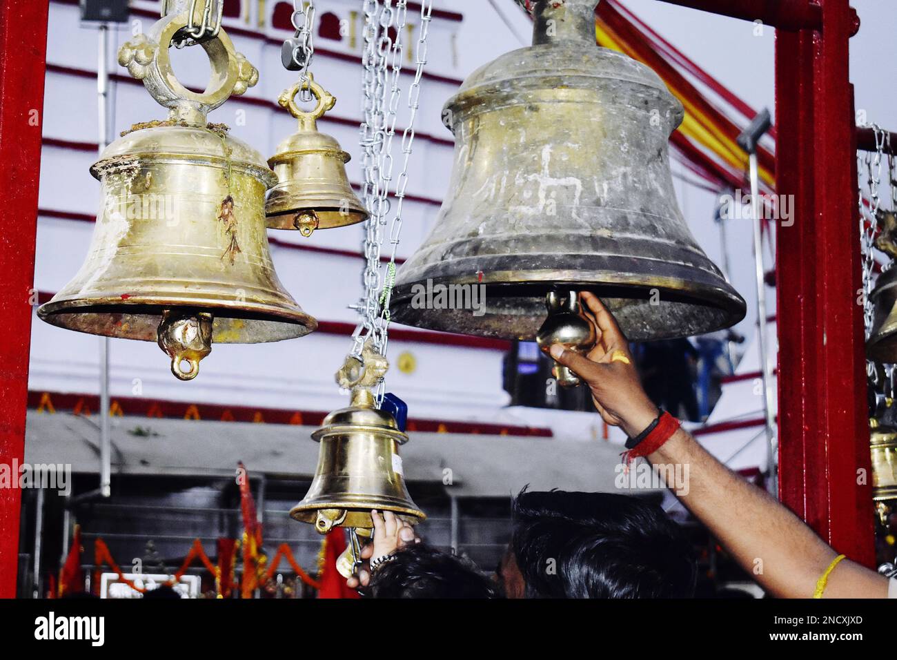 A hand ringing on a temple bell Stock Photo - Alamy