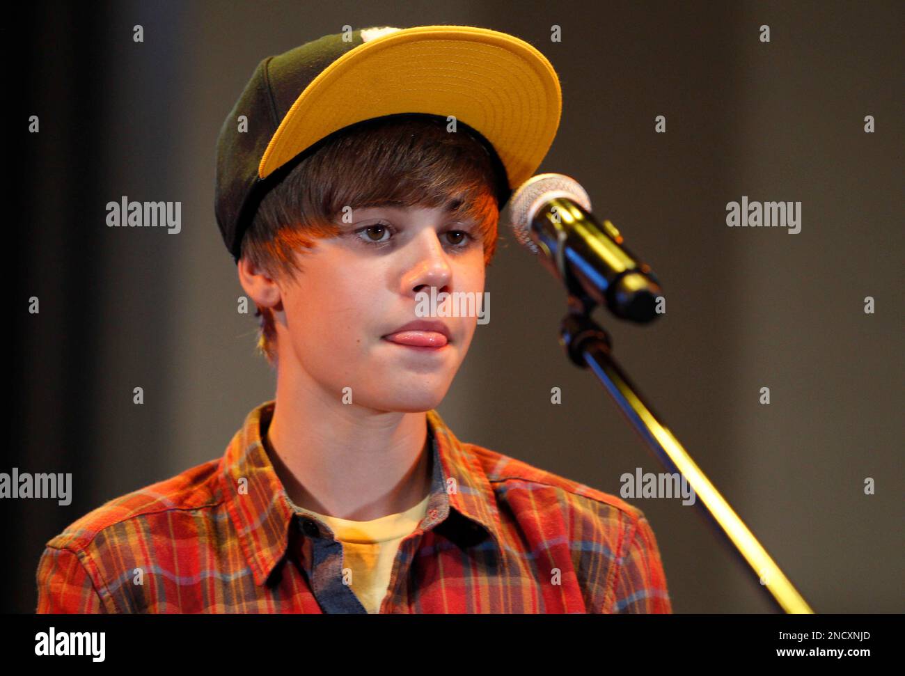 Canadian singer Justin Bieber bites his tongue during a