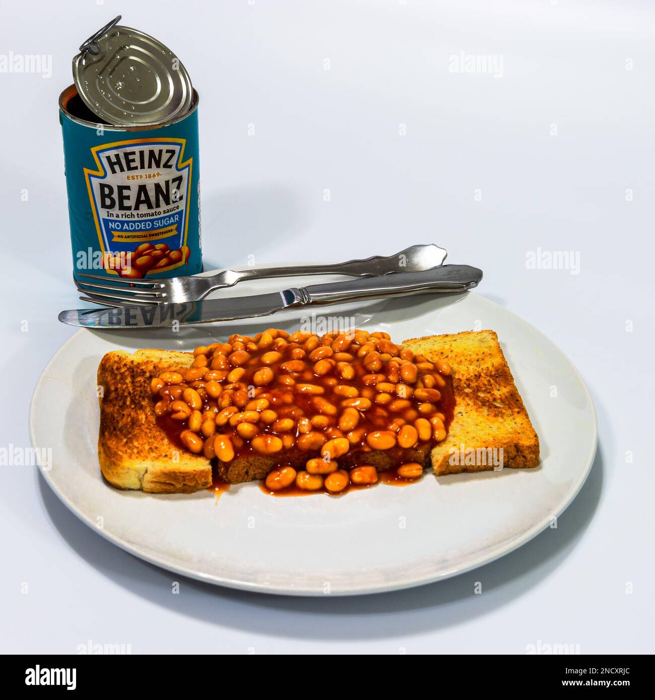Heinz Beans on Toast with cutlery and the open can Stock Photo Alamy