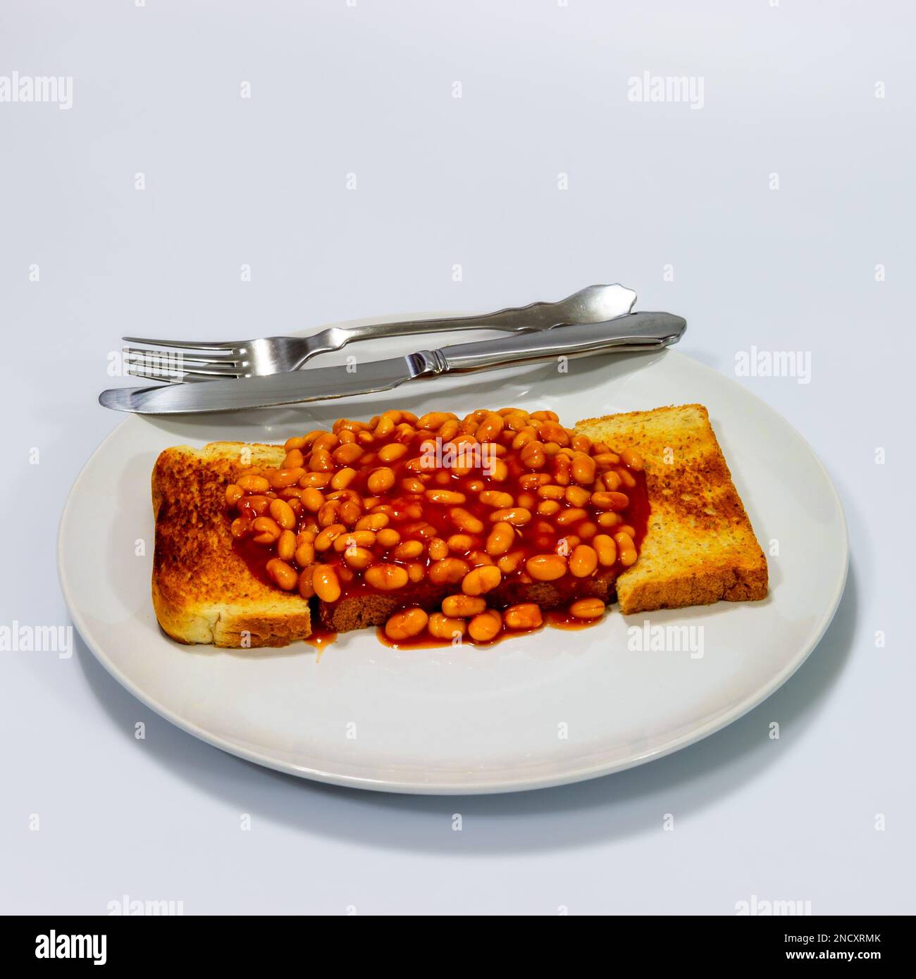 Beans on Toast with cutlery Stock Photo Alamy