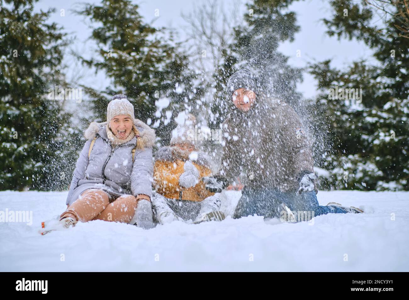 portrait of a cheerful family. happy kid and parents in the winter ...