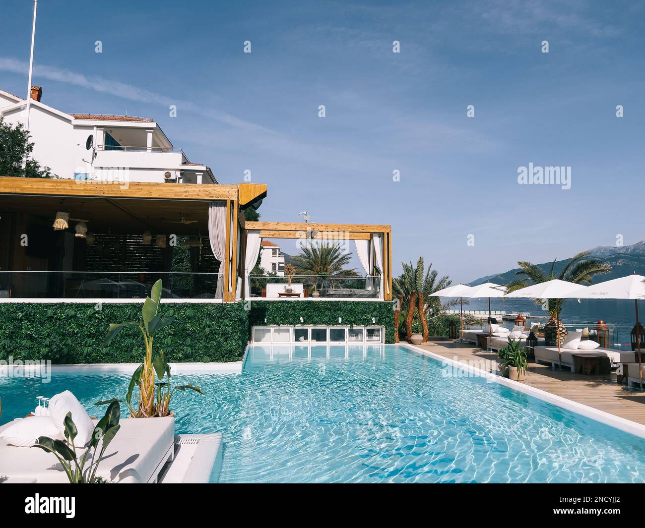 Wooden awnings over double sun loungers by the pool Stock Photo Alamy
