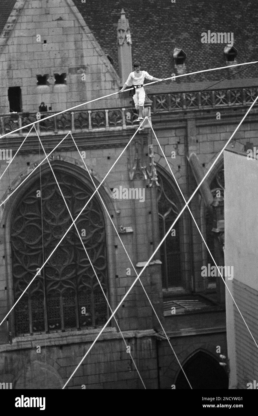 French tightrope walker Philippe Petit walks on a cable wire between the Centre Pompidou and