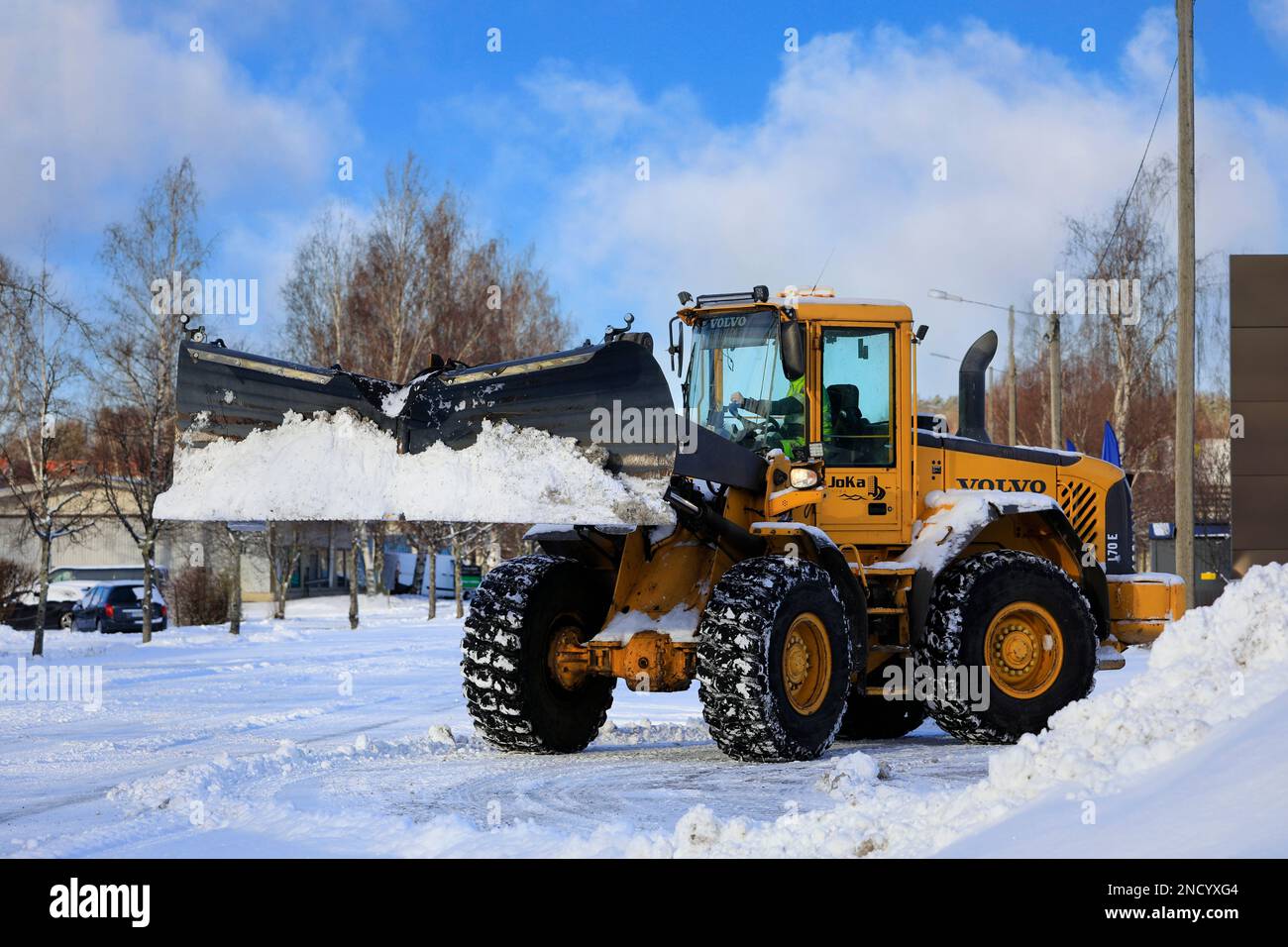 Removing snow with Volvo L70E wheel loader equipped with snowplough ...