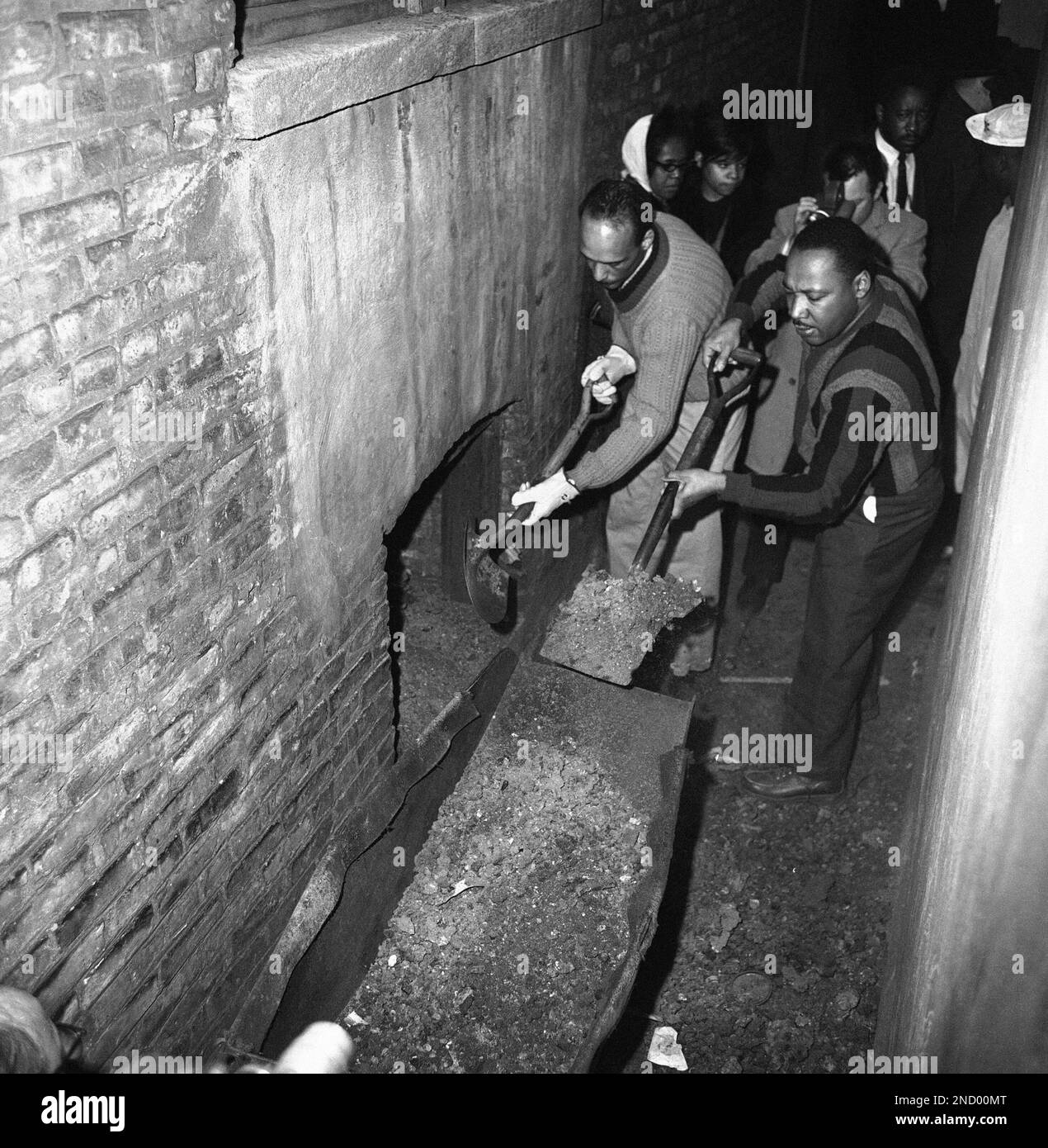 Martin Luther King attacks slum conditions at an apartment building in