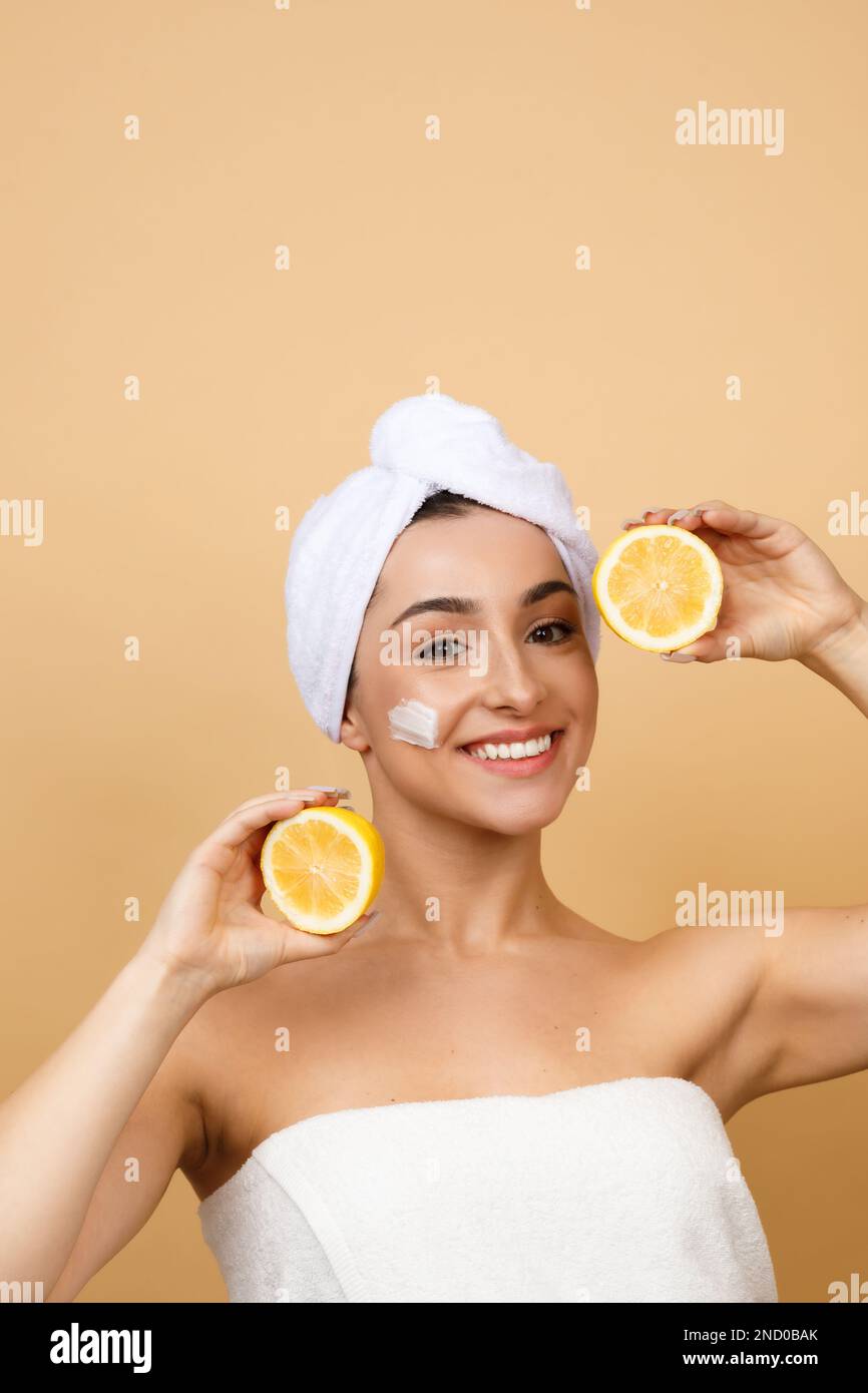 Vitamin C For Skin. Indian Female Wrapped In Towel Holding Lemon Halves Stock Photo Alamy