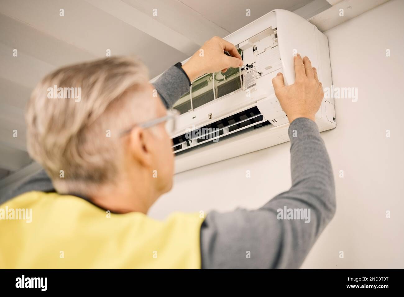 Maintenance, installation and back of a man with air conditioner for