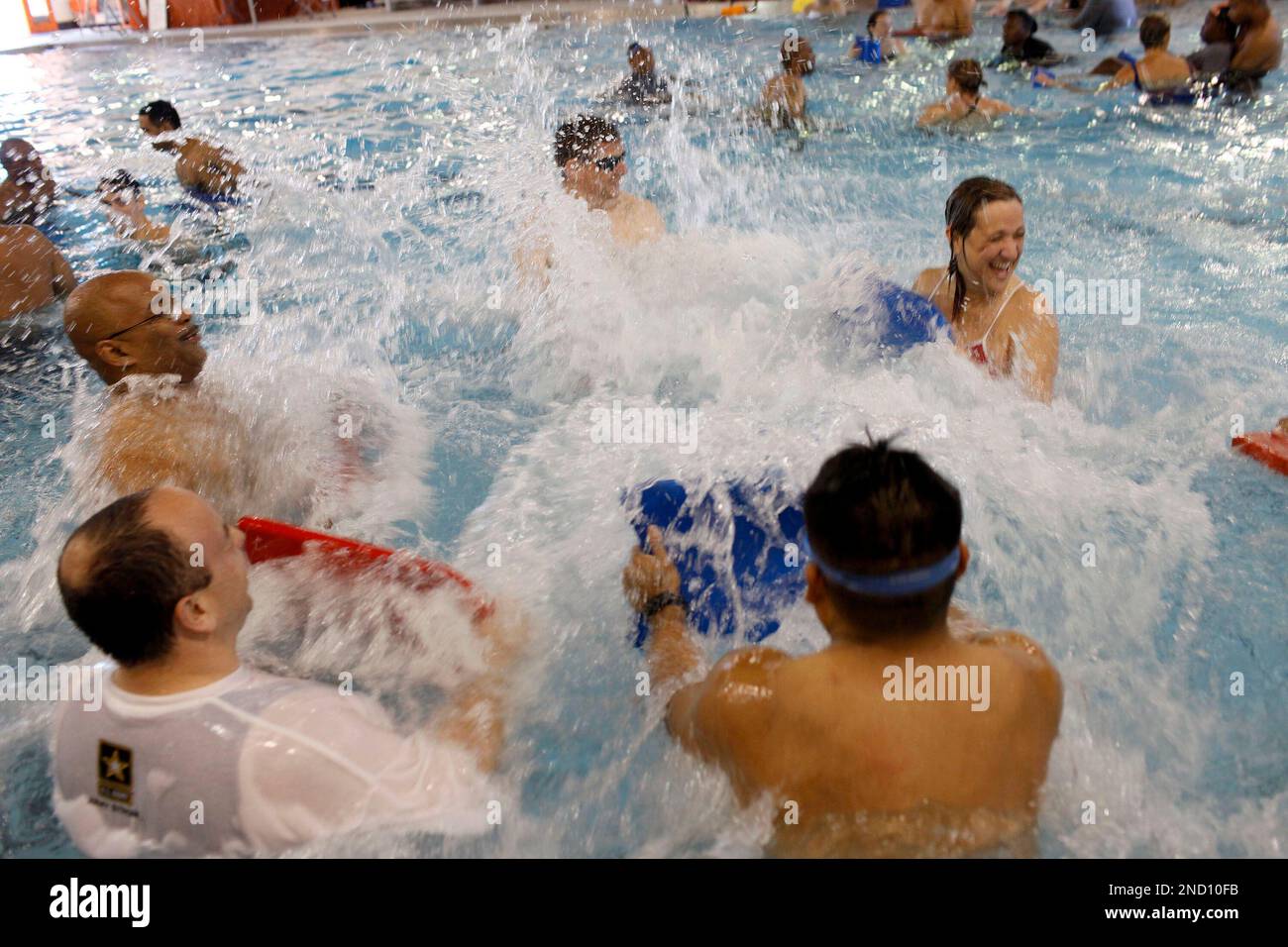 In this photo taken Sept. 29, 2010. soldiers from various Army Warrior  Transition Units from throughout the country splash water with kick boards  as part of a water therapy training session in