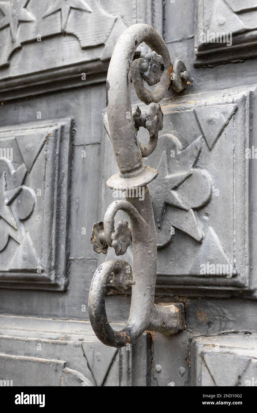 Antique iron door knocker of a spanish building dating back to the 17th century Stock Photo