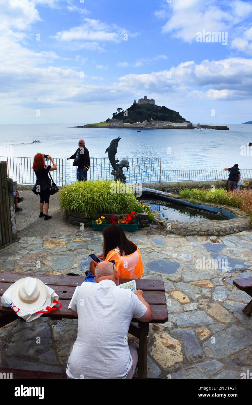 Tourists relaxing at Marazion with St. Michael's Mount in the ...