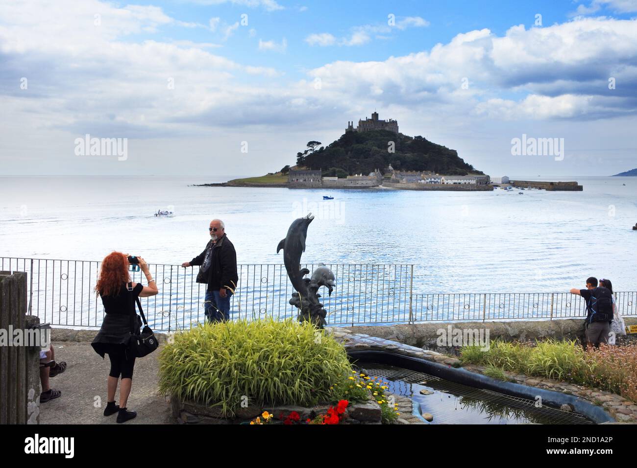 Tourists relaxing at Marazion with St. Michael's Mount in the ...