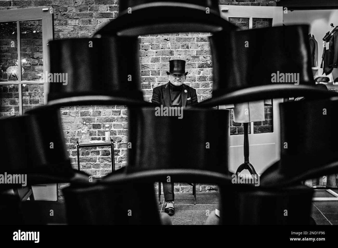 Black and white image of 'the last stop for the curious vintage' that sells top hats at Spitalfields Market in east London. Stock Photo