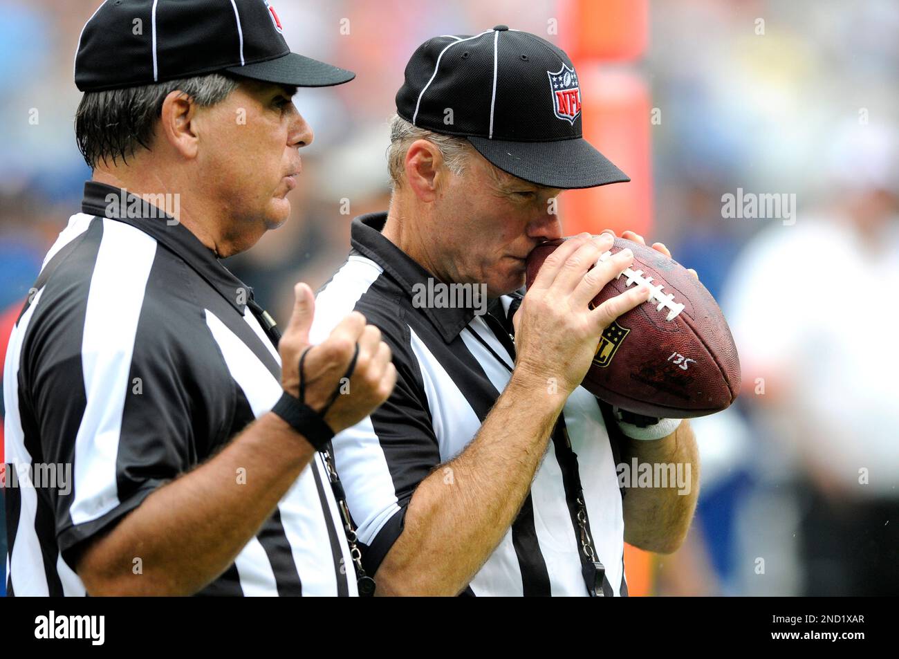 Head linesman, Hayward talks with side judge Don Carlsen during