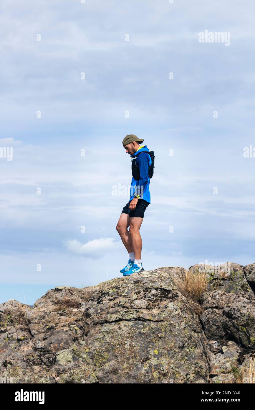 Young man practising trail running on a mountain top Stock Photo