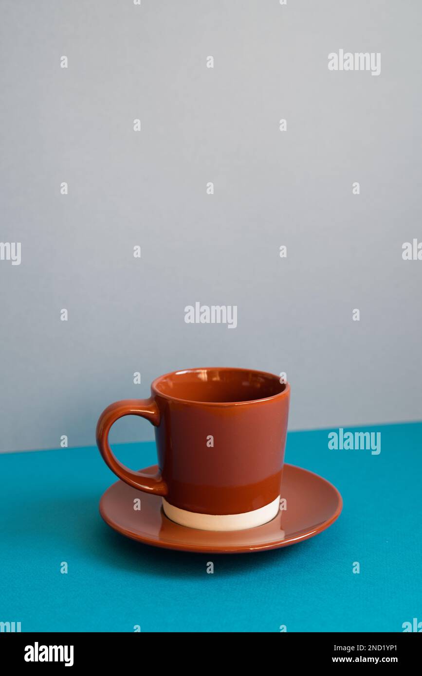 Brown coffee cup on blue table Stock Photo