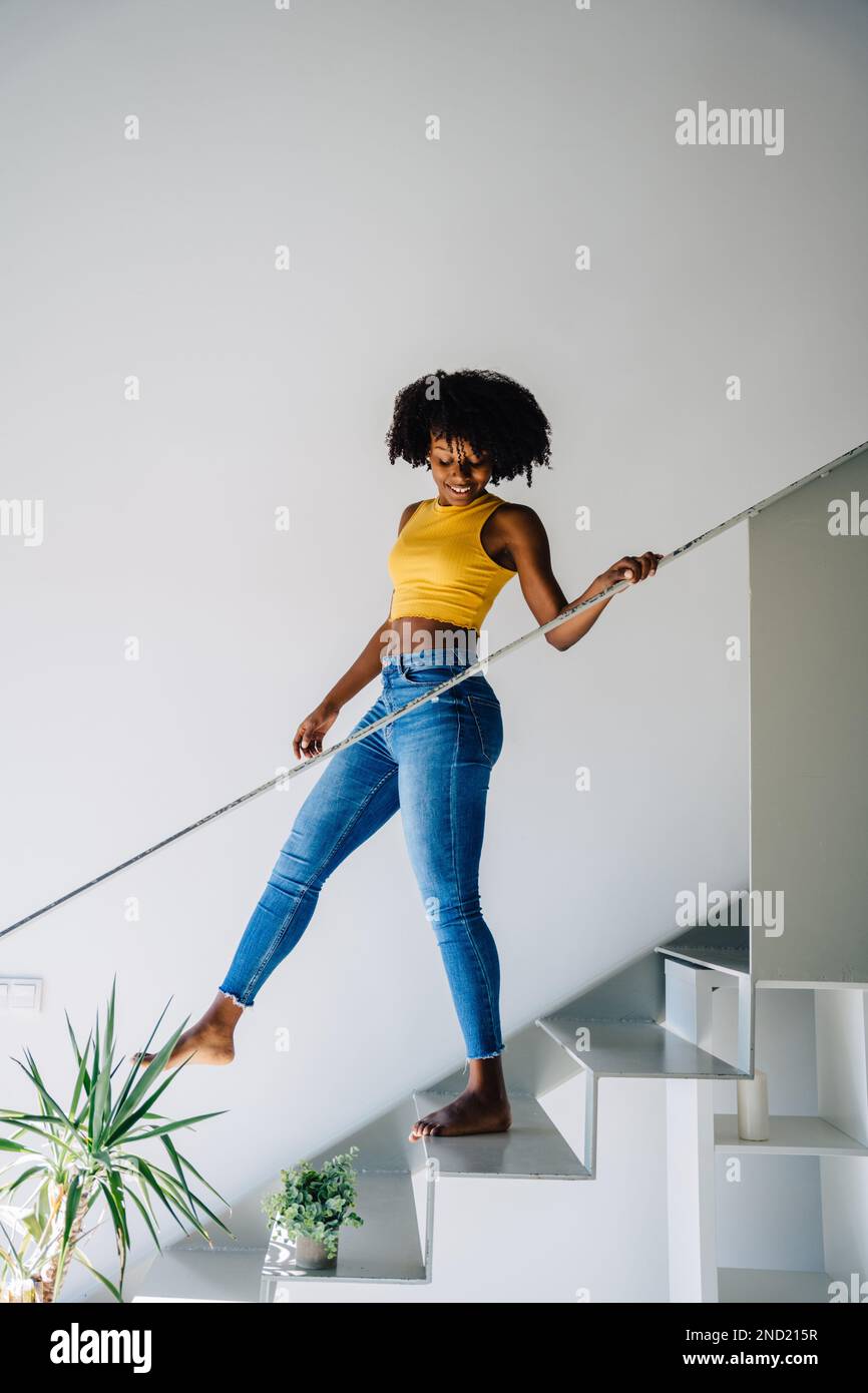 Full body of smiling young African American female in casual outfit ...
