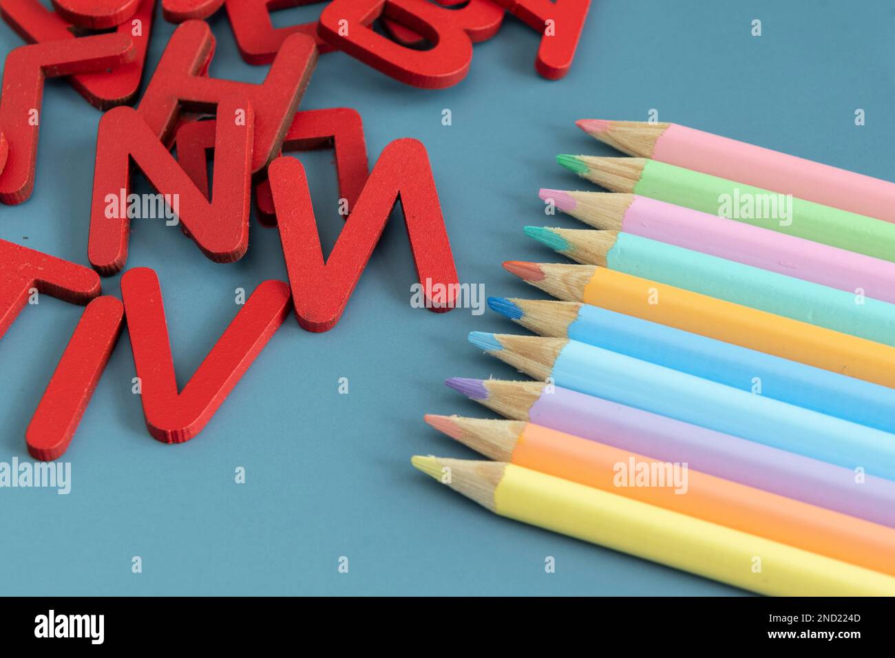 Back to school concept with assorted letters and colored pencils in ...