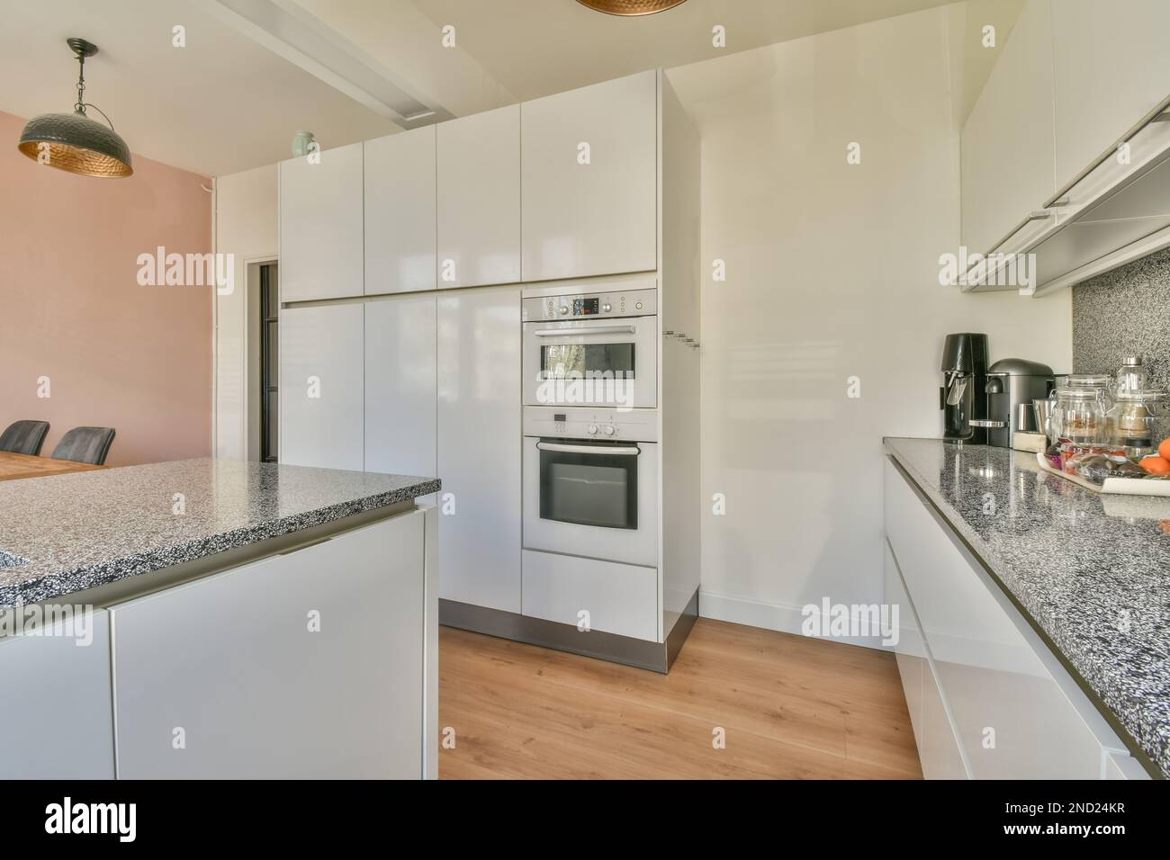 Picture of Interior of kitchen with white cabinets in light apartment Stock Photo ...