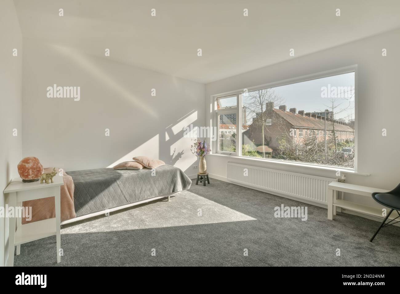 Interior of modern bedroom with comfortable bed against window and