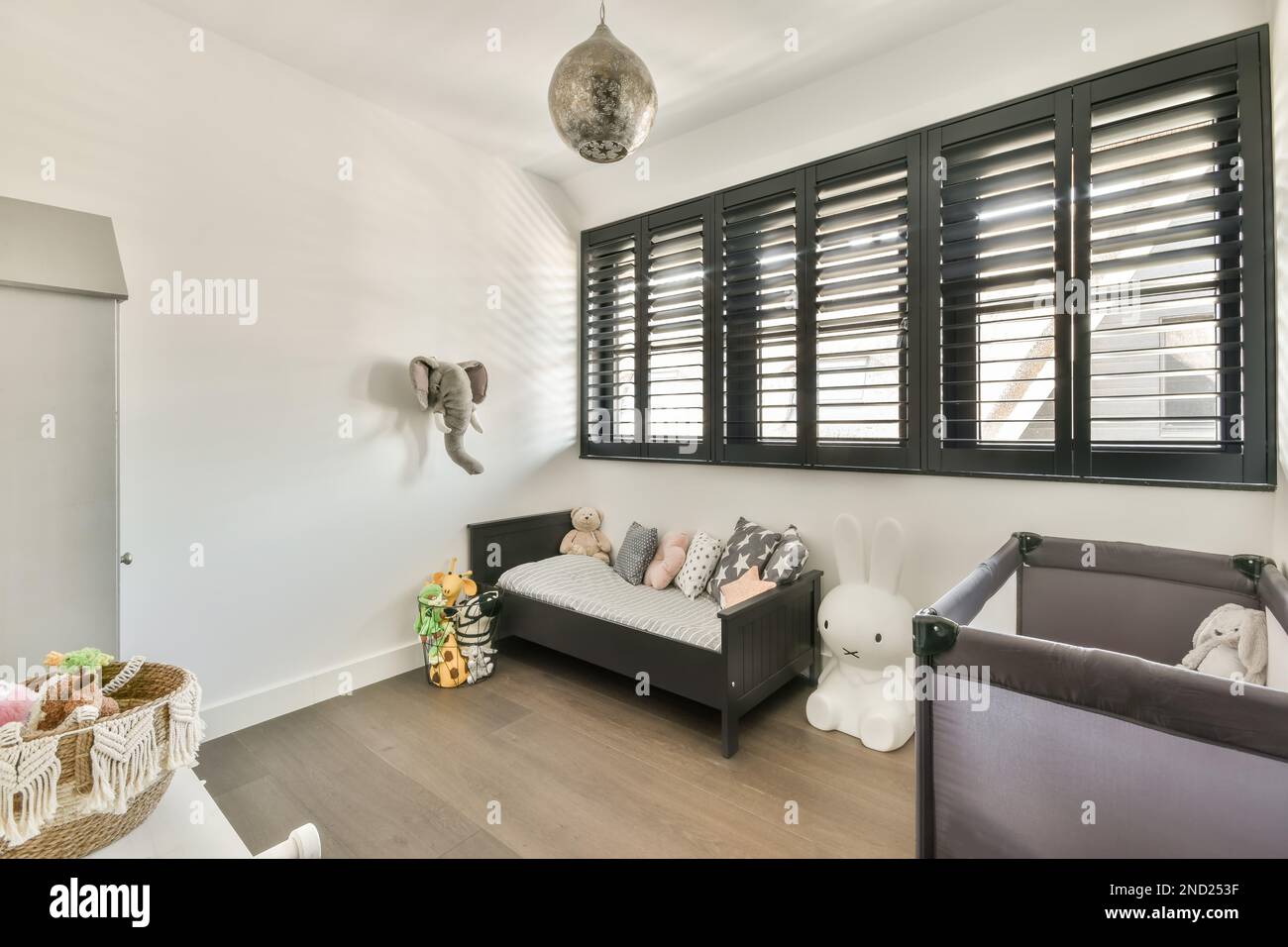 Interior design of nursery room with small toddler bed portable crib