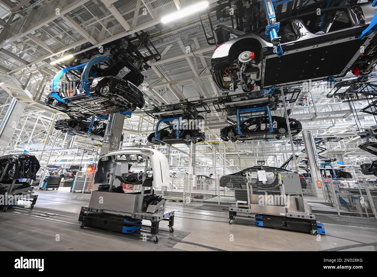 Sindelfingen, Germany. 13th Feb, 2023. Vehicles of the Stuttgart-based car  manufacturer Mercedes-Benz are transported on a conveyor belt through the  factory halls in Factory 56 at the Merecdes-Benz plant in Sindelfingen,  Germany,