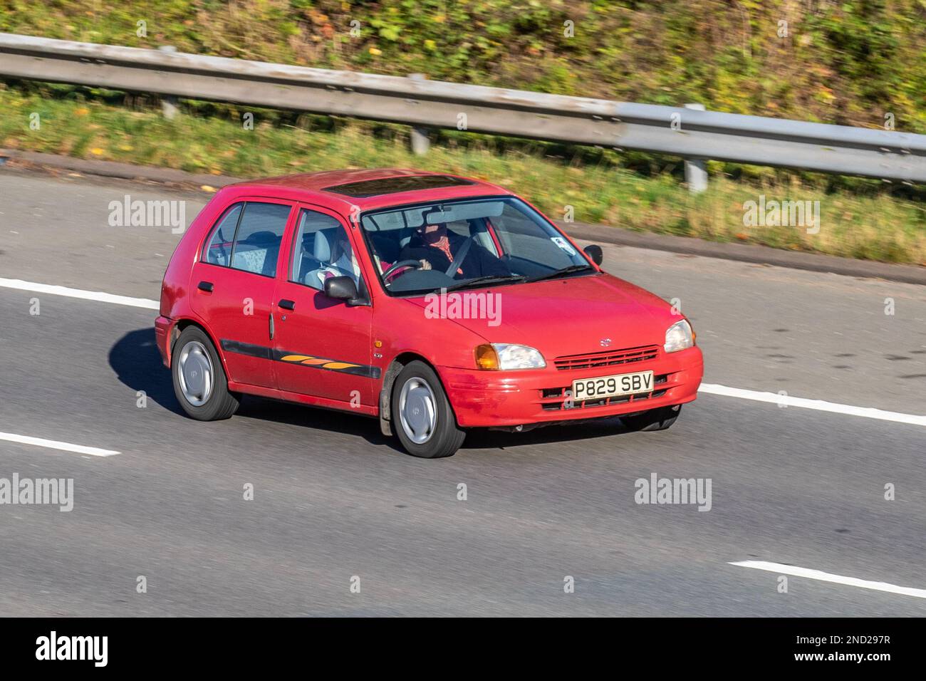 1996 90s nineties Red TOYOTA Carina E Solair Se Petrol 5 speed manual, Hatchback Petrol 1587 cc; travelling on the M61 motorway, UK Stock Photo