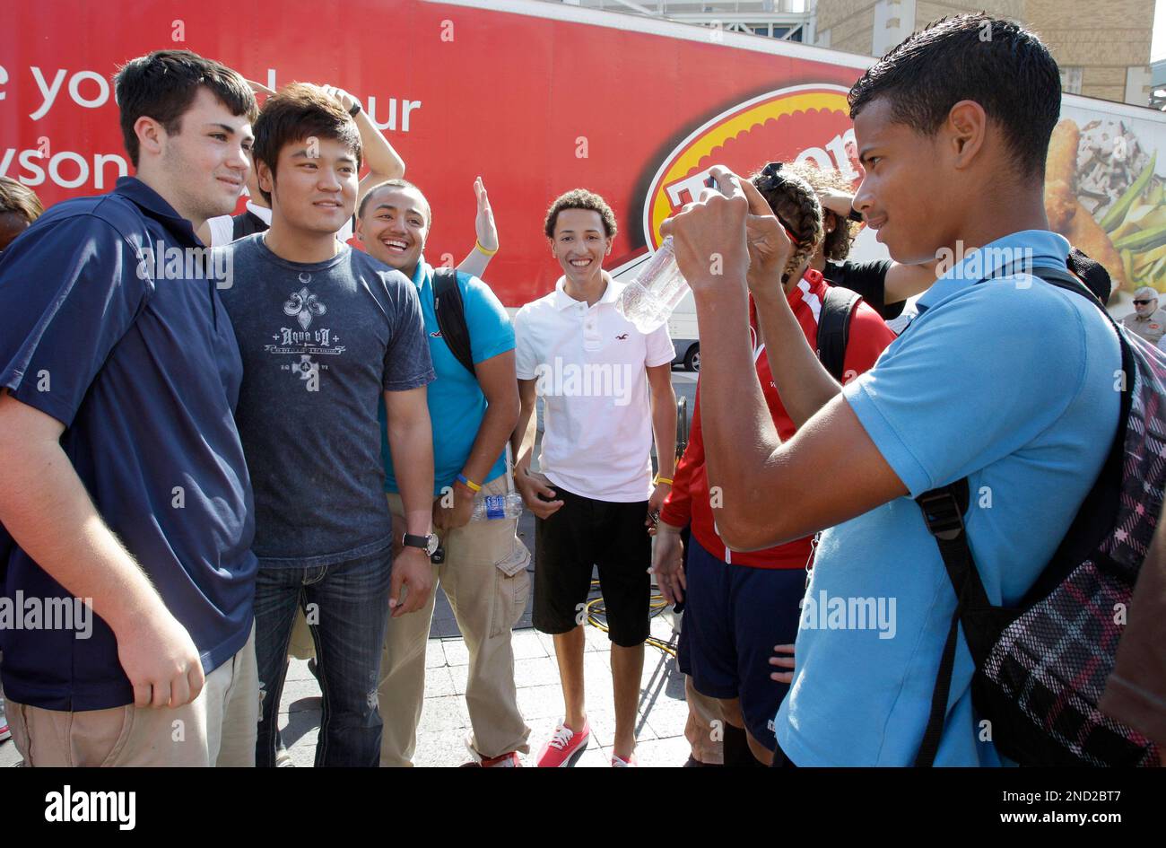 Jamsel Melendez, right, takes a picture of some other children