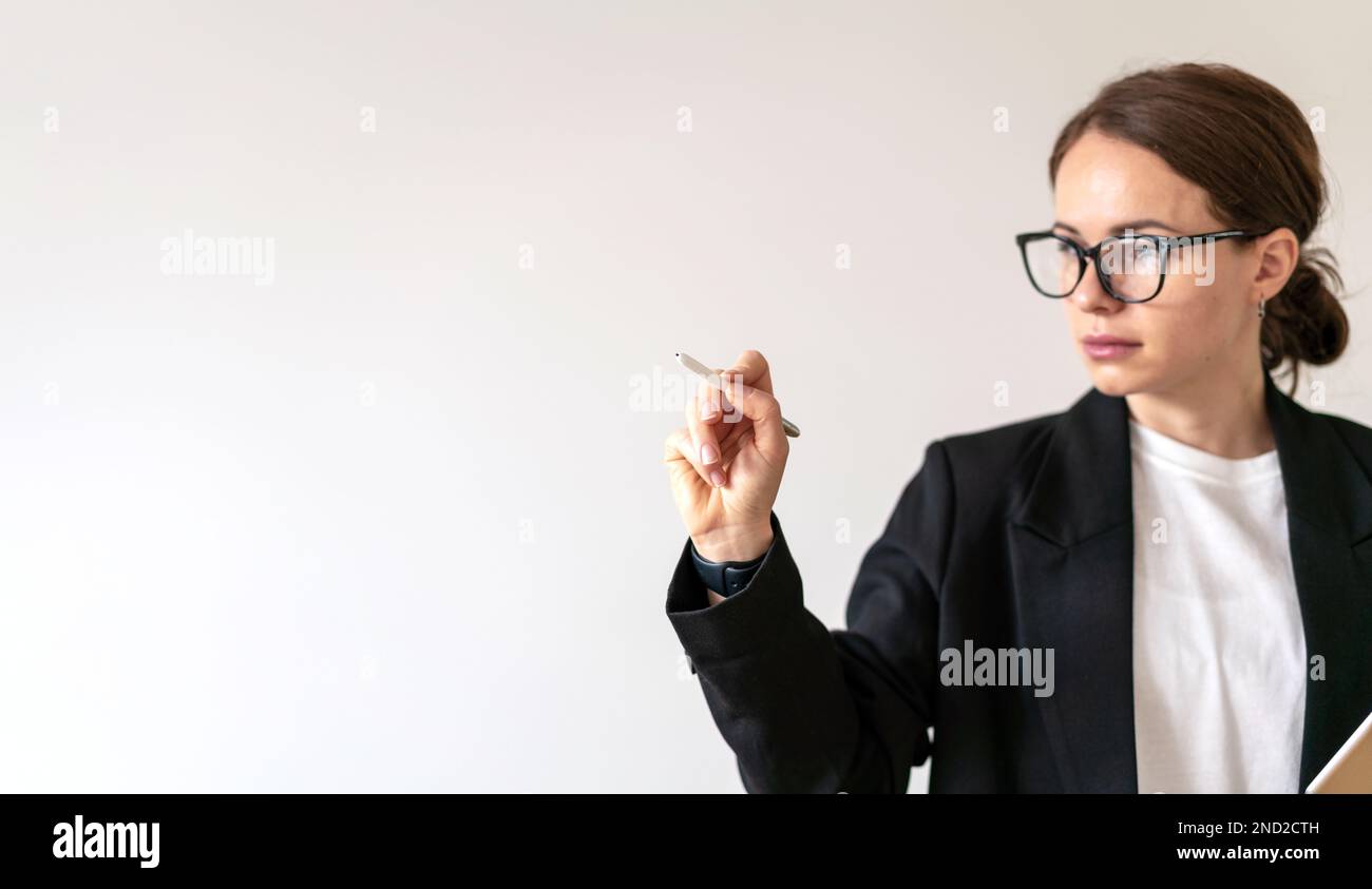 Defocused woman in glasses working with virtual screen interface infographic using digital touch pen. Stock Photo