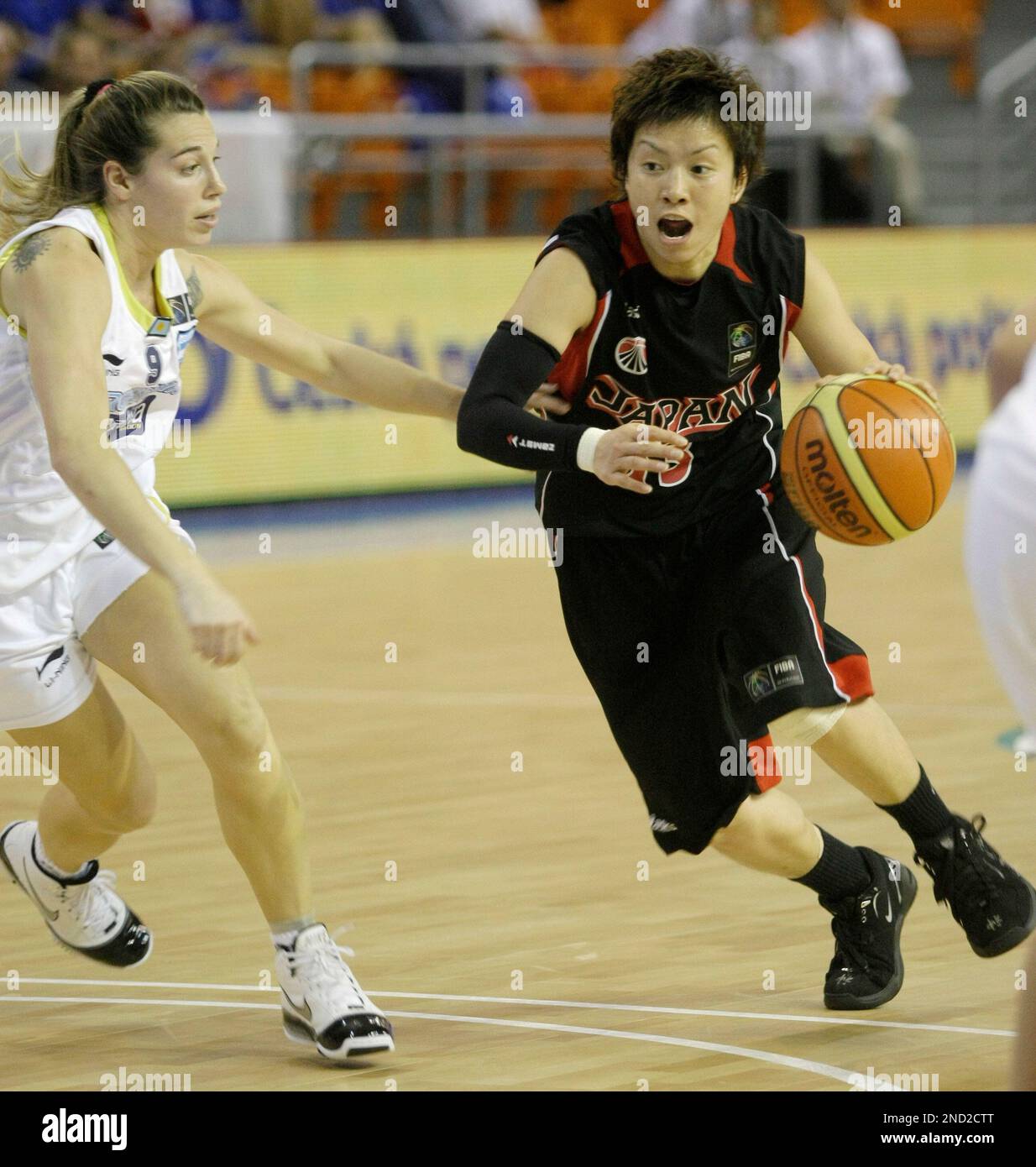 Yuko Oga, right, from Japan drives a ball past Marina Cava, left, from