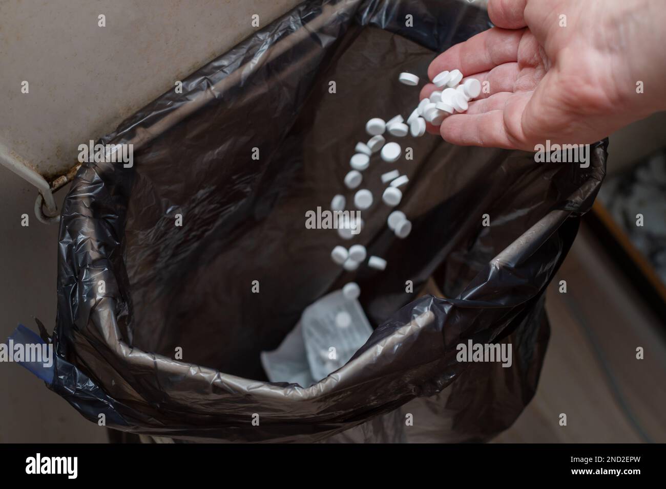 Throwing pills into the garbage illegal disposal Stock Photo Alamy