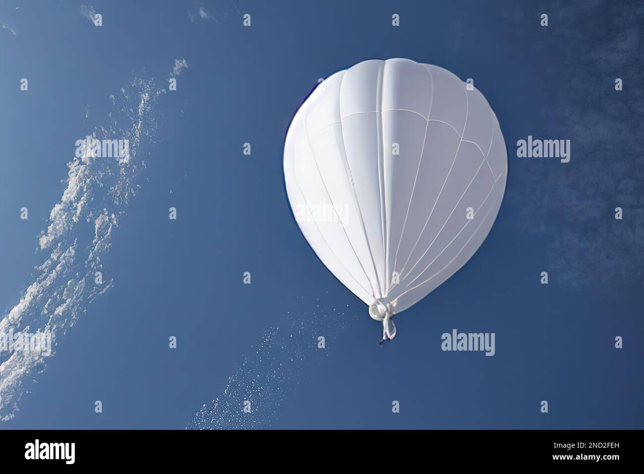 A Chinese-made white meteorological probe is shown flying in the sky, violating the airspace in its pursuit of atmospheric reconnaissance and research Stock Photo