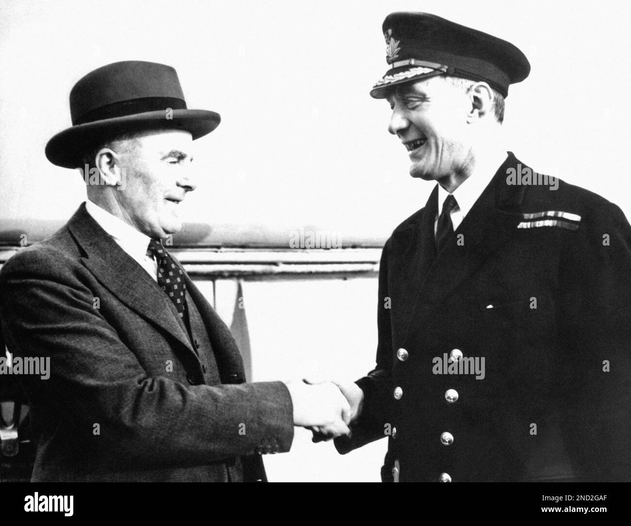 Capt. Robert B. Irving, right, congratulating Sir Edgar Britten who was ...