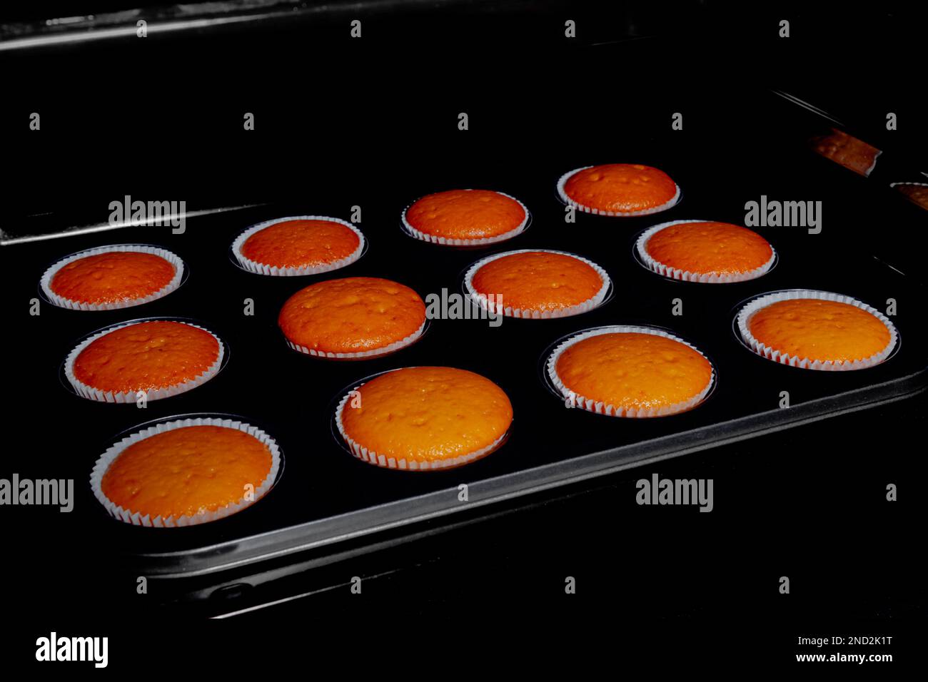 Twelve baked cupcakes, muffins in electric oven Stock Photo Alamy