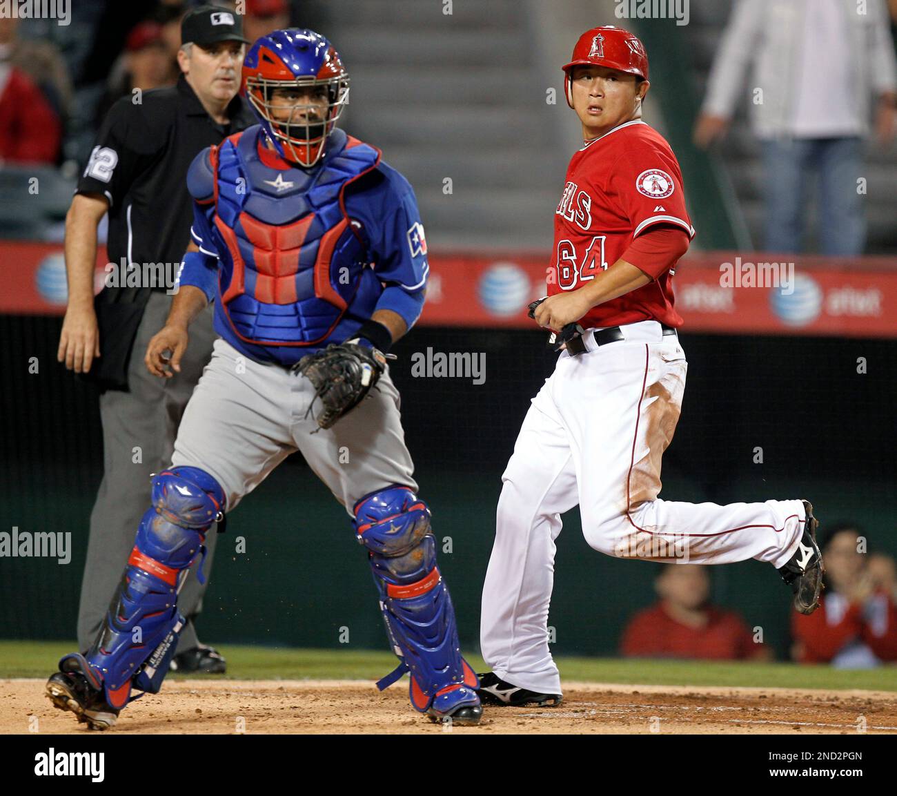 Los Angeles Angels' Hank Conger, right, scores past Texas Rangers catcher Bengie Molina on a