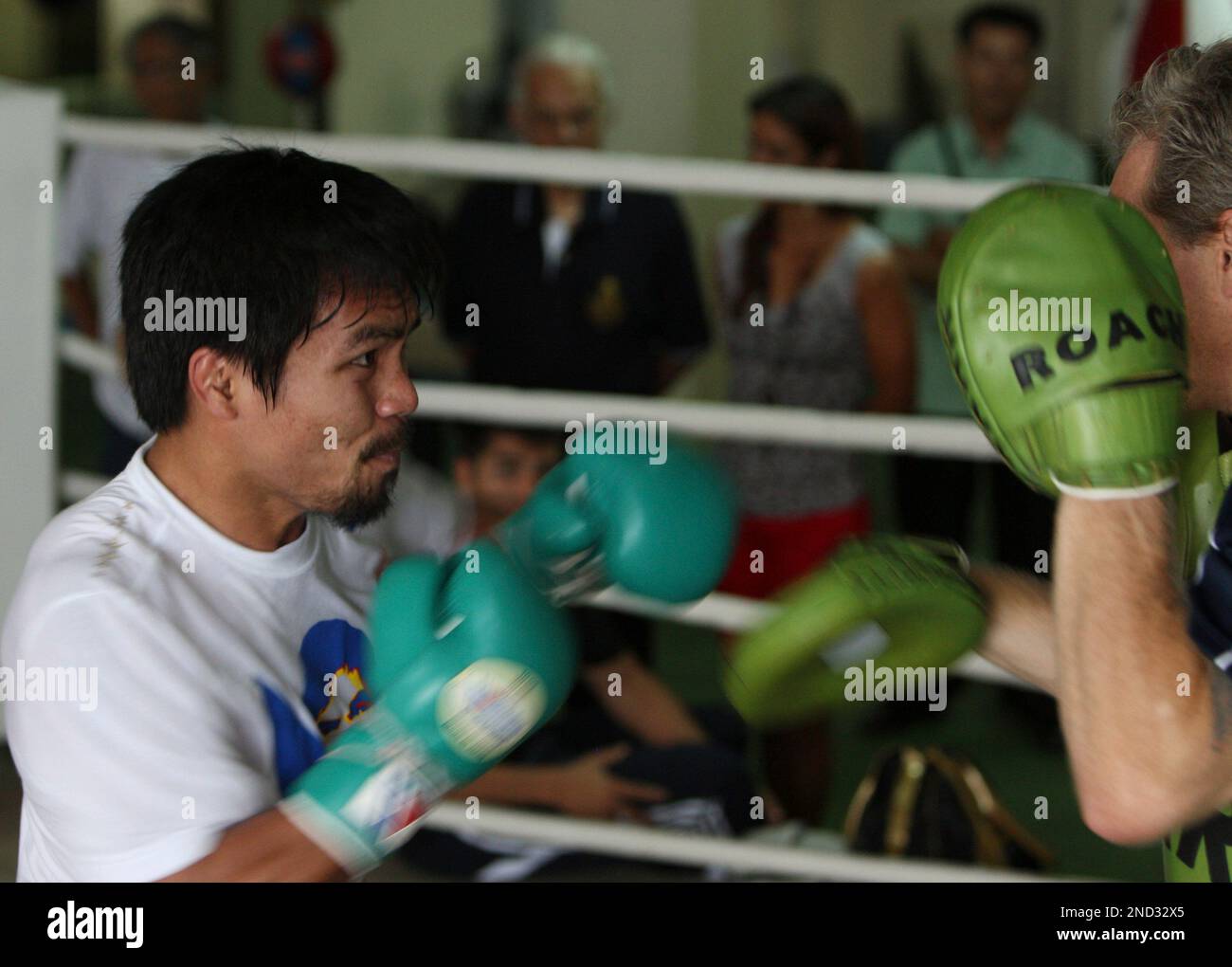Filipino boxing champion Manny Pacquiao, left, spars with trainer Freddie Roach as he embarks on a training at the Elorde Gym Monday Sept