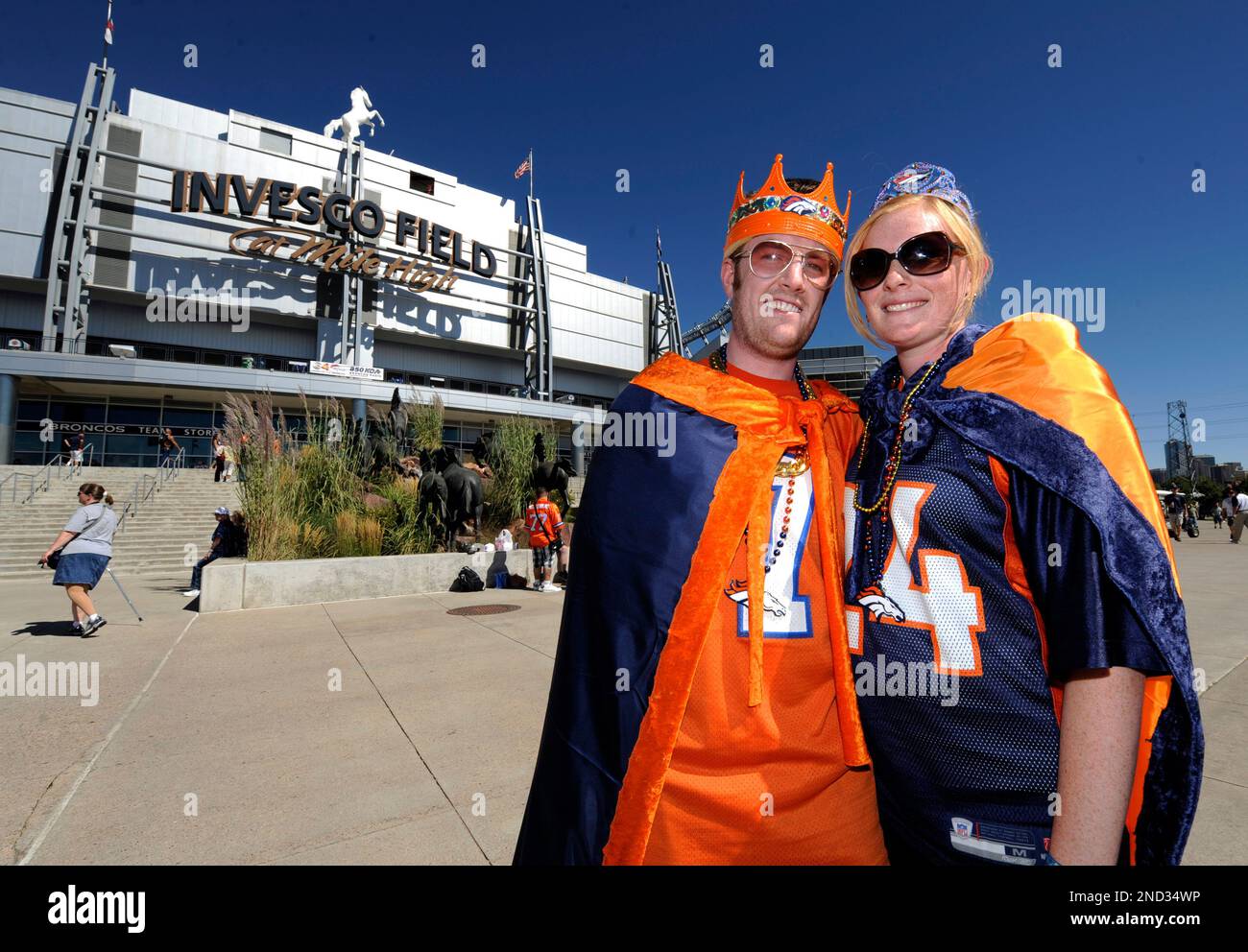 Fans pose in front of a Seahawks throwback uniform during a Seattle Seahawks  Back Together Weekend event at the NFL football team's training facility,  Sunday, July 30, 2023, in Renton, Wash. (AP