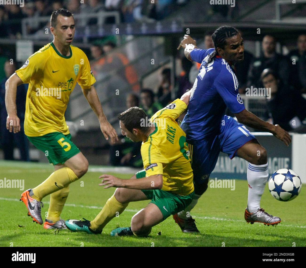 Chelsea's Florent Malouda, right, fights for the ball with Lubomir ...