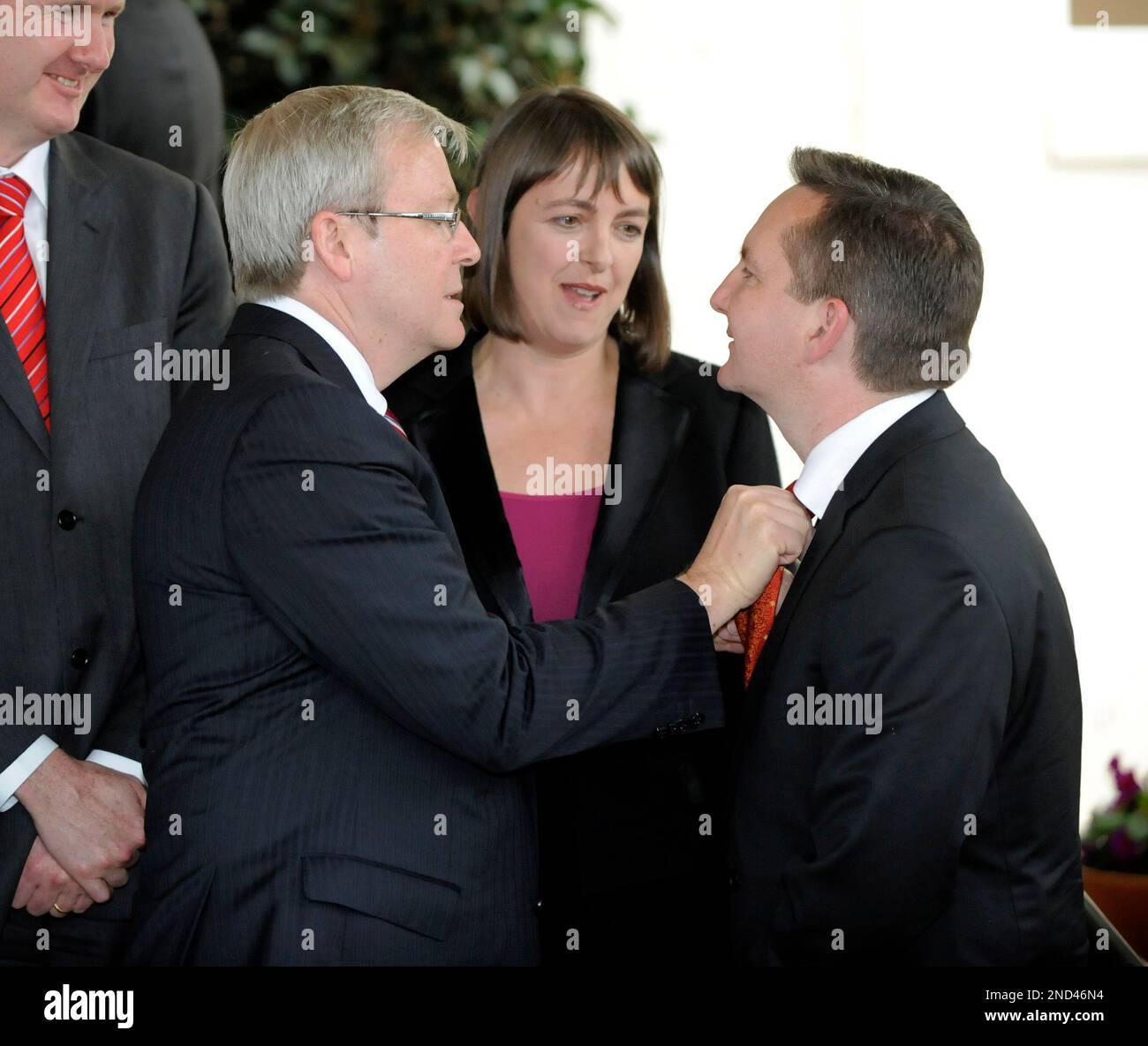 Former Australian Prime Minister Kevin Rudd, front left, adjusts the ...