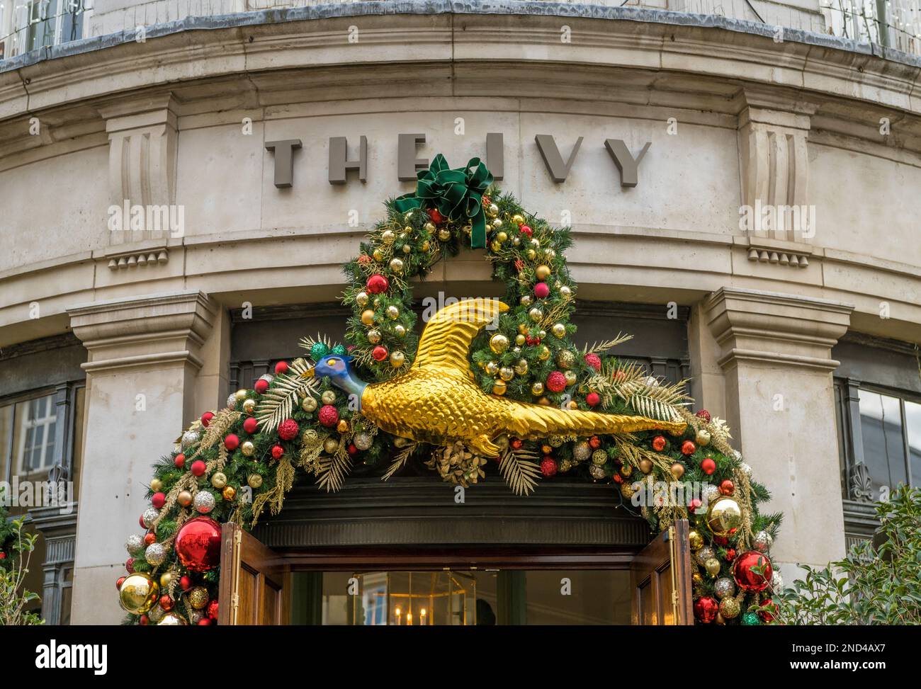 Exterior façade of The Ivy restaurant in York with the entrance decorated with Christmas baubles and a large gold partridge. York UK Stock Photo